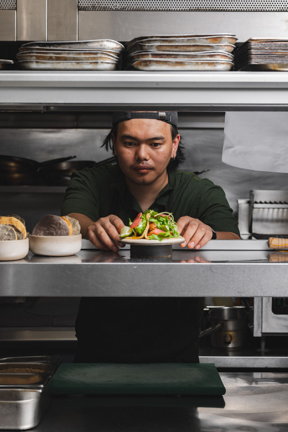 Chef plating a salad at the kitchen pass at Ixchel Mexican restaurant, King's Road Chelsea, London hospitality lifestyle photography
